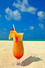 Fruity cocktail is on a beach