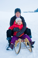 mother and daughter on a sled
