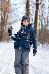 Fototapeta na wymiar Happy kid playing in the snow