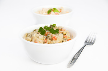 Bowls of potato salad with fork on isolating background