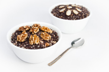 Two bowls of traditional Kutia dessert with a spoon on isolating