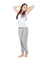 Fototapeta premium Young beautiful brunette lady stretching after awaking