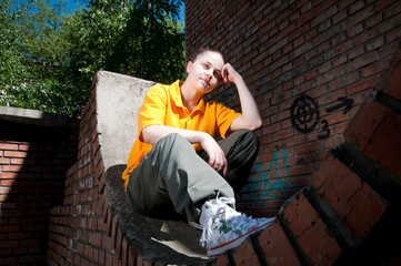 Teenage hip-hop girl on red brick wall