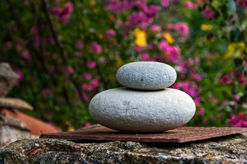 Obraz na płótnie Canvas Zen-like balanced rounded stones in garden