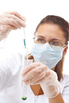 Female chemist using test tubes