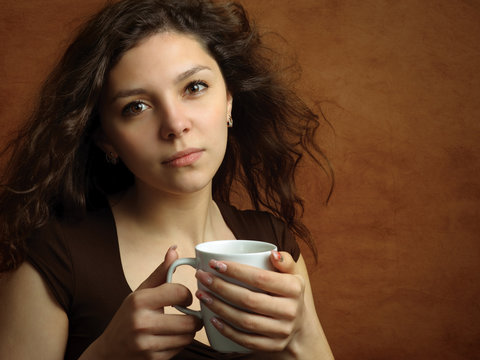 Young woman with cup of hot drink