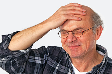 laughing man slapping a hand on his head