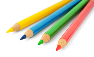 Isolated pencils. Four multicolored pencils isolated on white background with selective focus