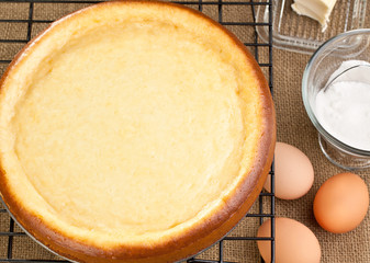 Whole fresh cheesecake with it's ingredients