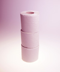 Three rolls of simple grey toilet paper made of waste paper