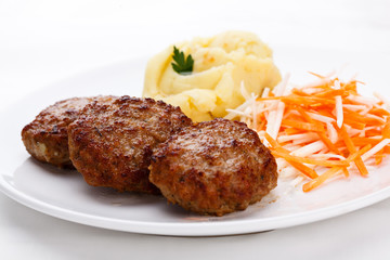 Fried steaks with potatoes and vegetable salad