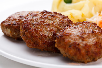 Fried steaks with potatoes and vegetable salad