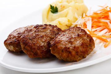 Fried steaks with potatoes and vegetable salad