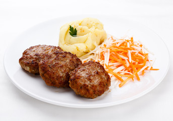 Fried steaks with potatoes and vegetable salad