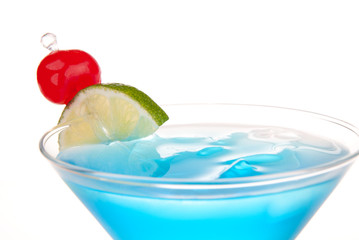 Blue Cosmopolitan cocktail with lime and cherry