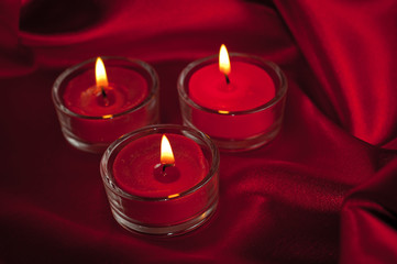 Valentines candles on satin background