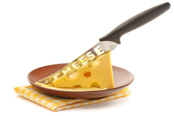 Appetizing cheese and knife on a brown plate