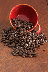 Coffe beans spilling from a cup
