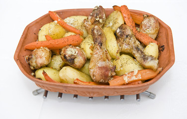 Roasted chicken and potatoes on a pot