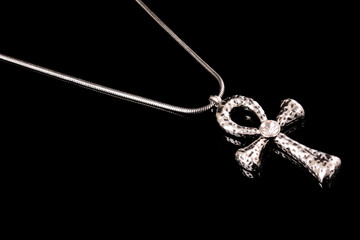 Egyptian ankh as pendant isolated on black