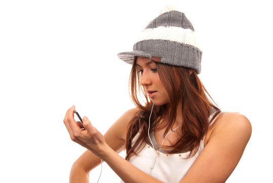 Female looking at cell phone in white headphones