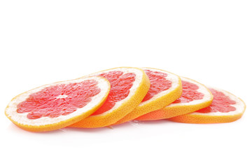 Slices of pink grapefruit isolated on white