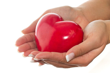 Female hands holding shiny heart