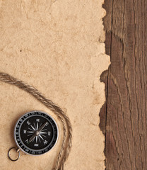 compass and rope on wood background