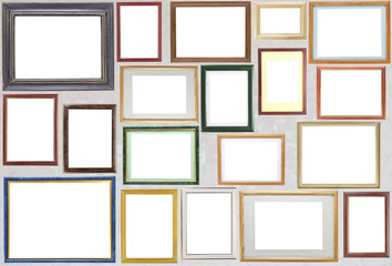 Various wooden photo frames  hang on a wall