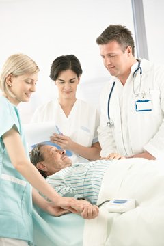 Doctors and nurse with older patient