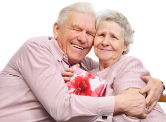 smiling elderly couple and box with gift