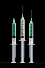 Syringes one filled with a one dollar bill