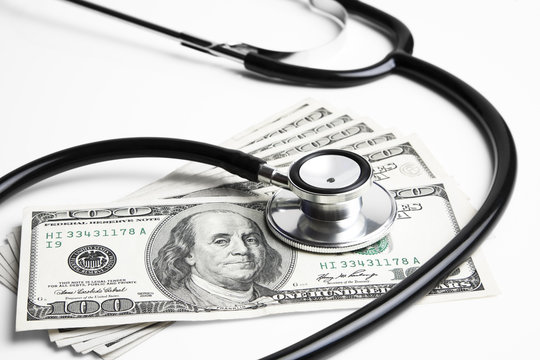Stethoscope and 100 dollar bills