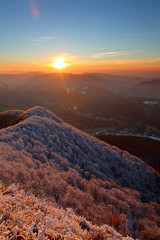 Frosty sunset panorama in beauty mountains from peak Strazov