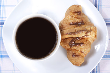 Cup of coffee and croissant