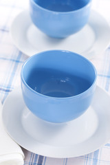 Two empty blue plates for the soup