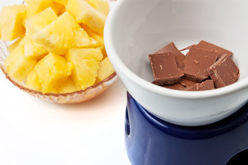 Chocolate fondue with pineapple pieces