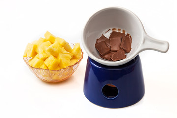 Chocolate fondue with pineapple pieces
