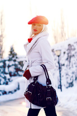 Young blond cheerful girl in the snow