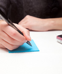 Woman writing on a notepad