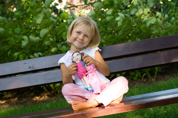 girl playing with dolls - obrazy, fototapety, plakaty