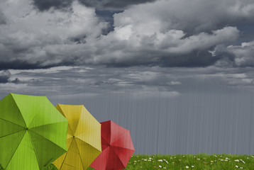 rainbow colored umbrella's in heavy rain to use as background