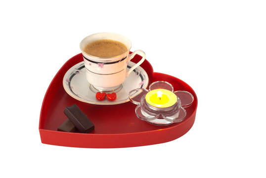 Romantic breakfast and small candle on red heart shaped tray