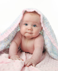 Beautiful baby under a blanket