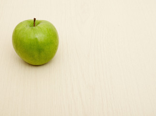 Green apple on wooden table