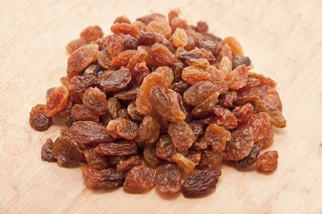dried grapes on wooden plate
