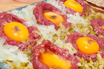 tartar steak with egg onion and pickle
