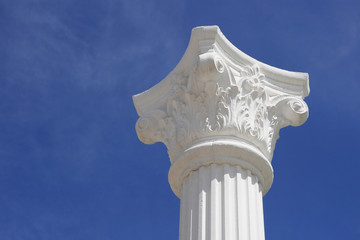 White lonely column and capital against the dark blue sky
