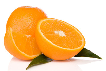oranges and green leaves isolated on white