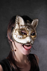 The young girl in the Venetian mask of a cat